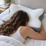 Close view of a shoulder resting in the curved cut-out of the pillow