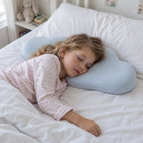 A girl of about six asleep on her side with her cheek in the hollow of the cloud pillow