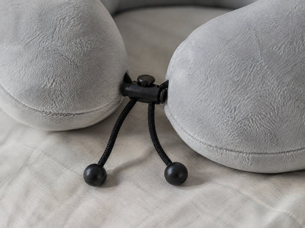 Macro photograph of the black drawcord and barrel toggle across the front of the pillow
